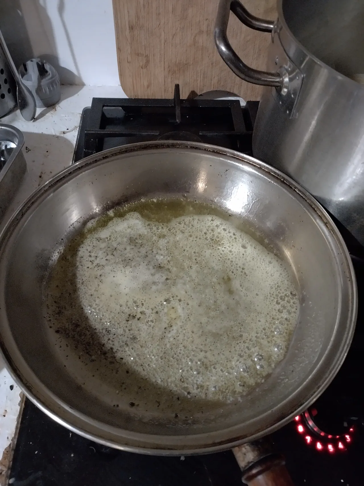 Butter, olive oil, and starchy pasta water emulsifying into a foaming cacio e pepe sauce base